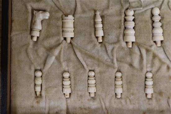 A bone travelling chess set and counters